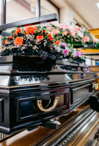 Casket with flowers on top of it