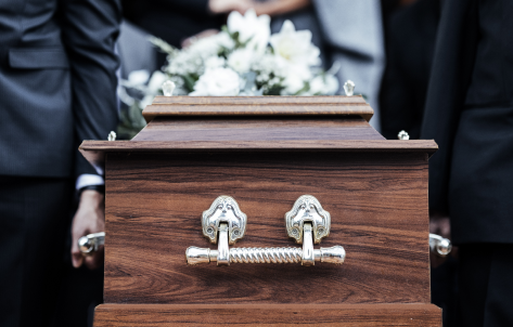 Casket with flowers on top of it