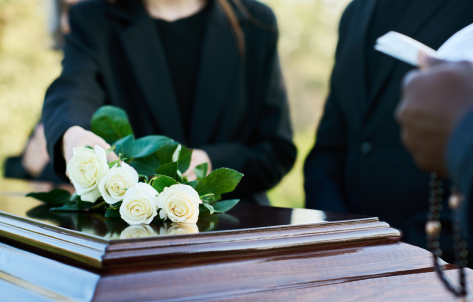 Casket with flowers on top of it