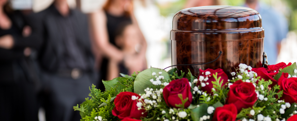 A cremation urn sitting on top of flowers
